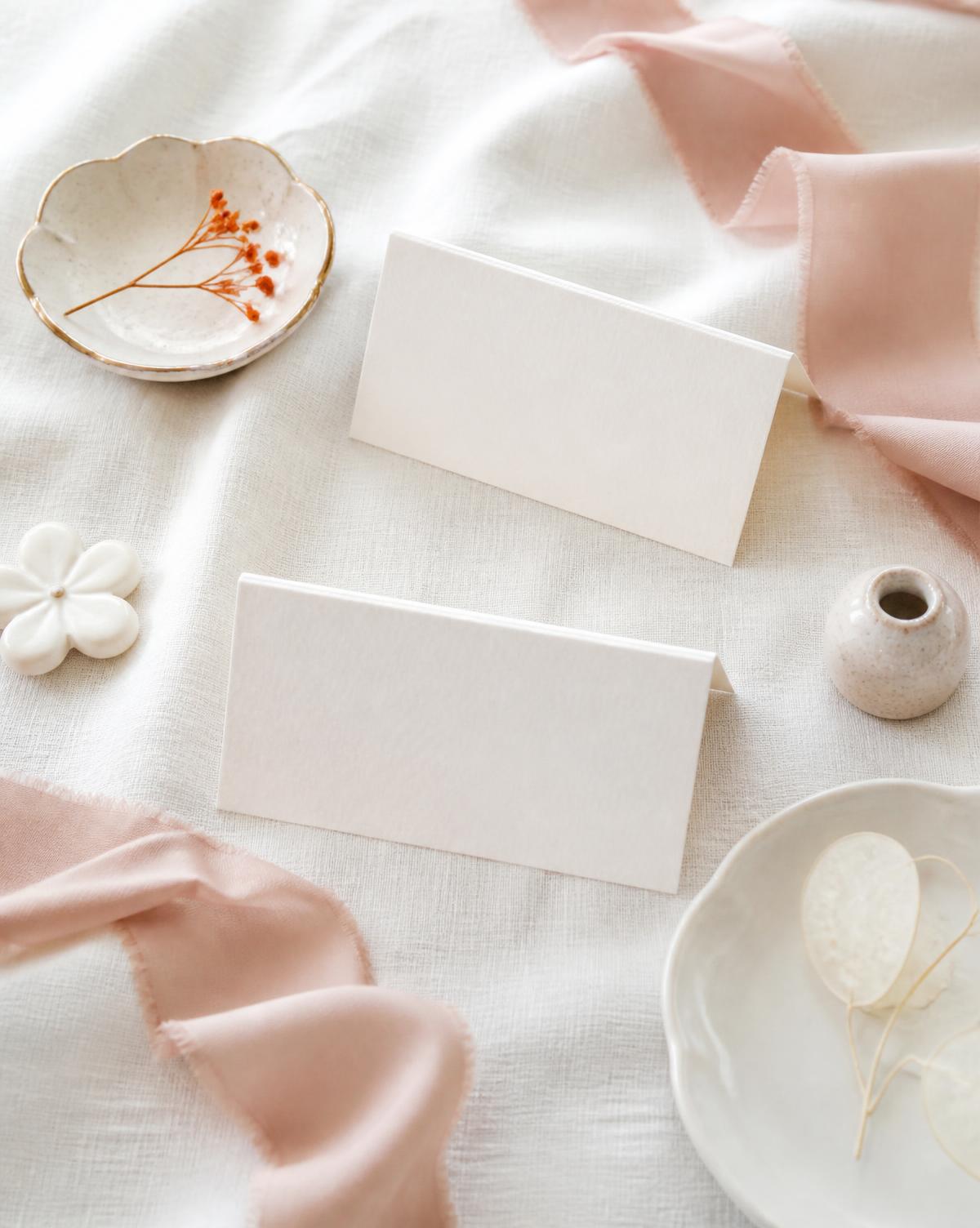 Styled event stationery on soft white linen