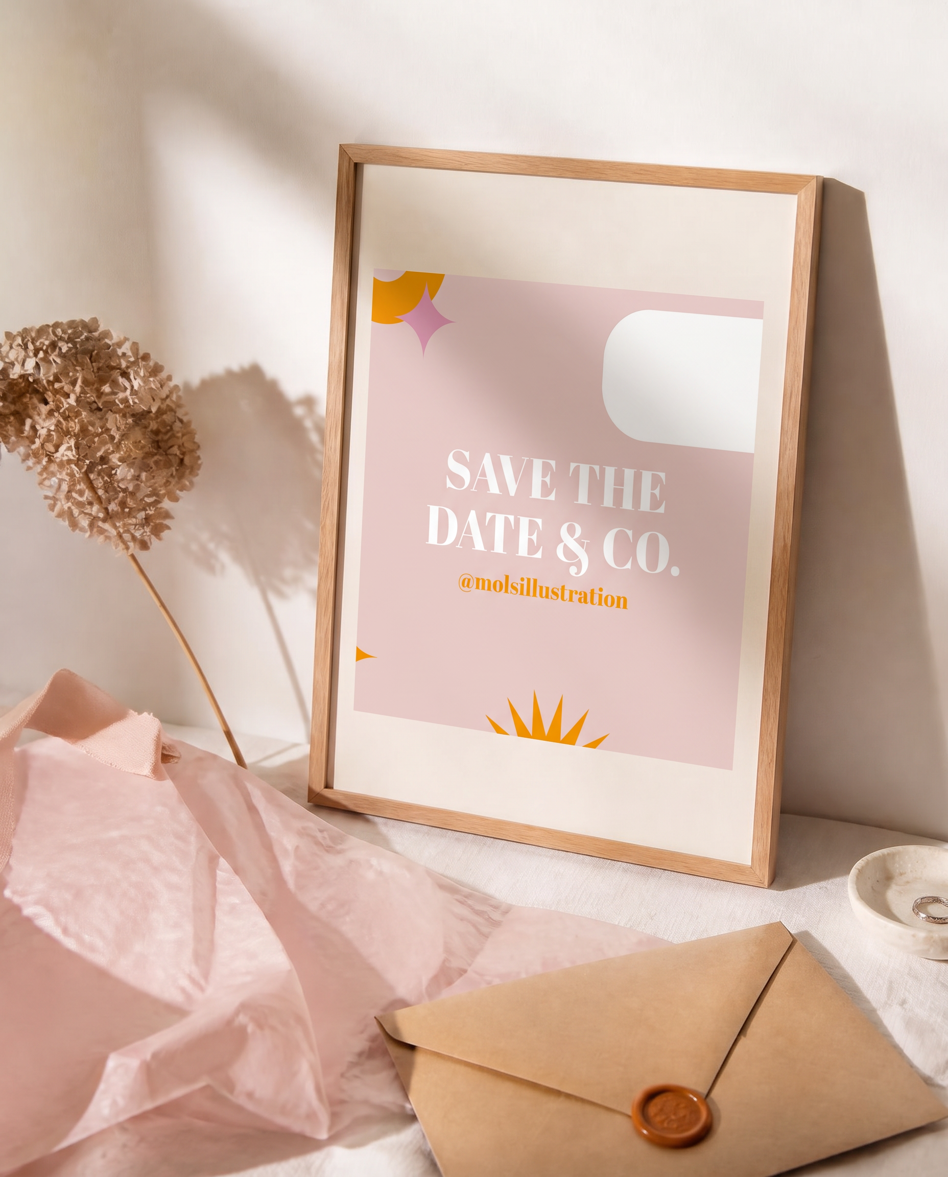 The Savethedate&co. logo print in a natural oak frame, styled with blush tissue paper and a wax-sealed envelope